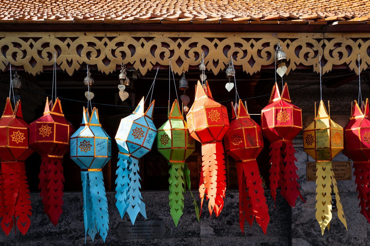 Colourful Lanna paper lanterns hanging under the eaves at Doi Suthep