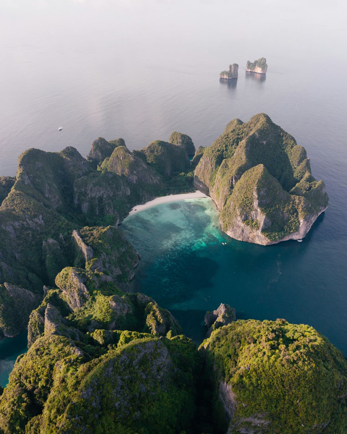 Aerial view of Maya Bay's turquoise cove surrounded by limestone cliffs